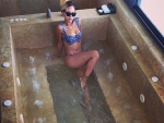Rihanna Enjoys in Bath Wearing Tiny Blue Bikini