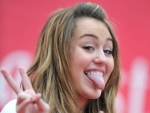 Miley Cyrus still can’t stop her Tongue wagging, went Brunette