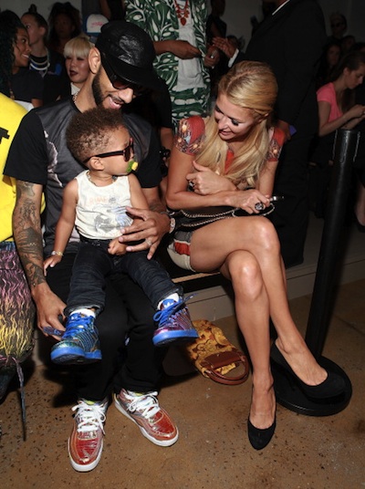 Swizz Beatz with his son and Paris Hilton attend the Jeremy Scott show during Spring 2013 Mercedes-Benz Fashion Week