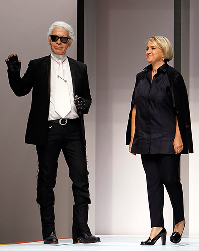 Karl Lagerfield and Silvia Venturini Fendi acknowledge the crowd at the end of Fendi's show