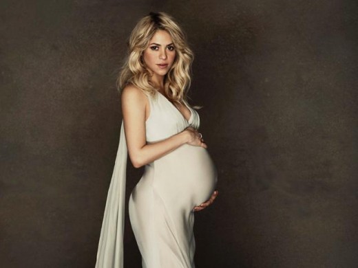 Shakira reveals her bump in intimate photo shoot.